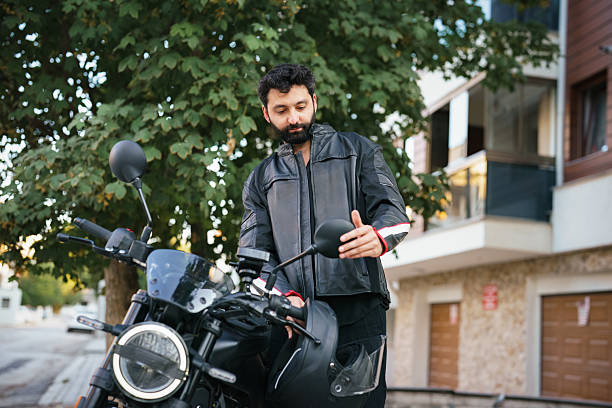 istock Motorcyclist checking motorcycle mirror outdoors 2232332856