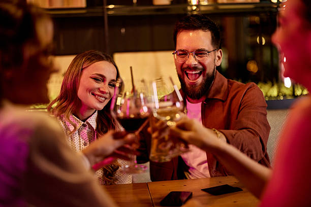 istock Young Friends Enjoying Drinks Together in a Relaxed Evening Venue 2232333138