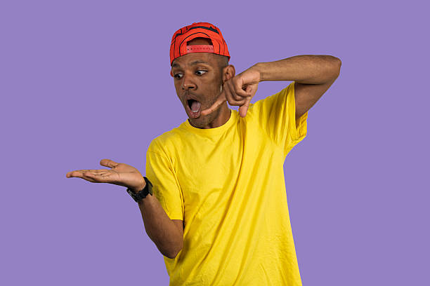 istock Young man showing something small with his hands and looking surprised 2232336547