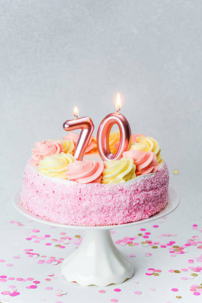 istock Celebrating a 70th birthday with a pink decorated cake on a festive table 2232337463