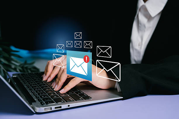 istock Professional Woman Using Laptop for Email Communication with Notifications and Digital Icons Symbolizing Messages 2232337800