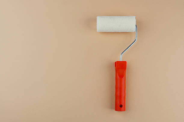 istock Paint roller with red handle on beige background for home decoration and DIY painting concept 2232338397