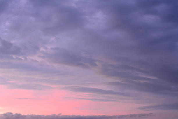 Evening Sky with Dramatic Clouds and Soft Pink Hues sunset background