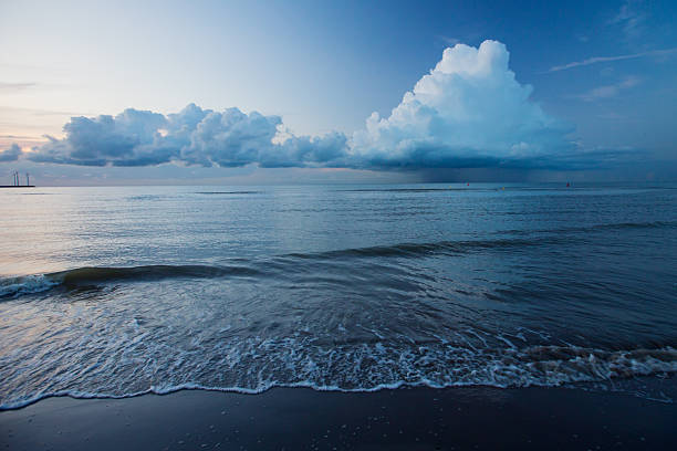 Stormy day with frothy waves by the Noth Sea in Denmark / Europe