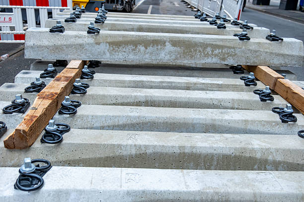 stack new concrete railway sleepers with metal fasteners, ready for track construction or repair, Railway infrastructure materials, modern transport infrastructure development