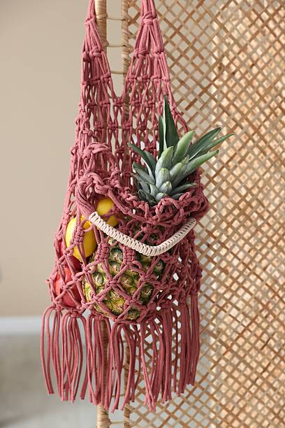 istock Macrame bag with fruits on folding screen indoors 2232344028