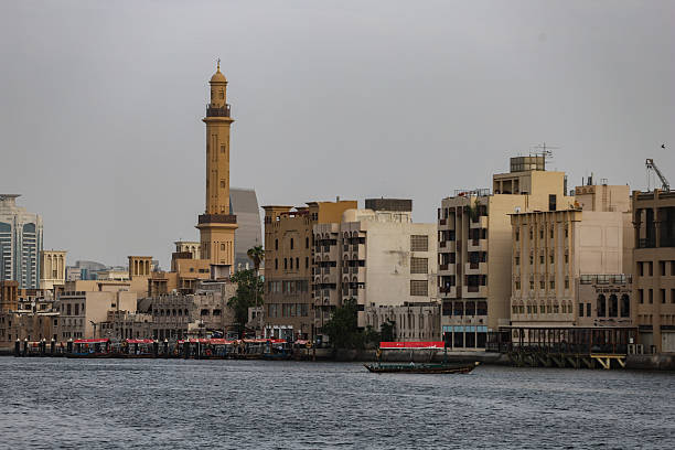 istock Old Dubai waterfront with mosque minaret and traditional buildings 2232344446