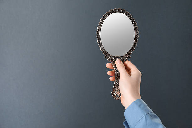 istock Woman holding vintage mirror on grey background, closeup. Space for text 2232345965