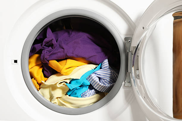 istock Modern washing machine with clothes in drum, closeup 2232347077