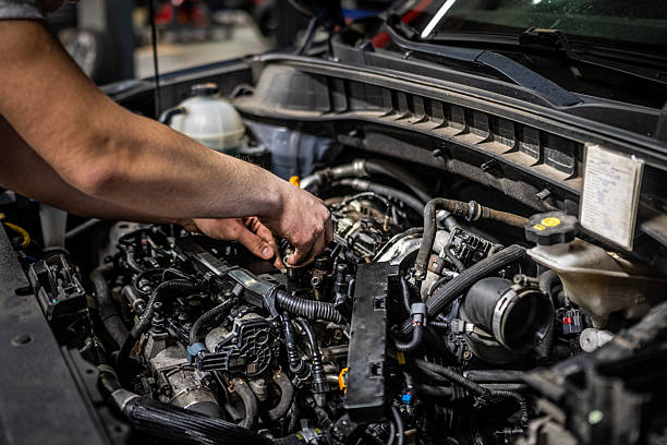istock Young Caucasian Car Mechanic Repairing Engine in Workshop 2232348973