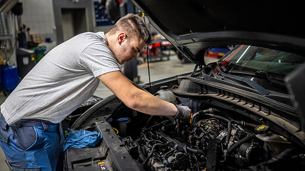 istock Young Caucasian Technician Inspecting Vehicle Engine in Repair Shop 2232348976