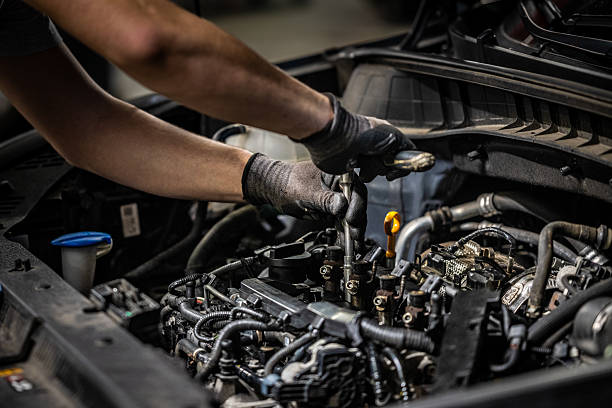 istock Caucasian Auto Specialist Performing Engine Repairs in Garage 2232348983