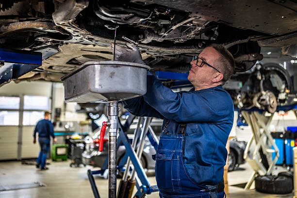 istock Mature Automotive Technician Replacing Engine Oil in Service Center 2232348985