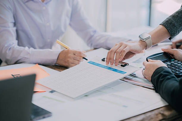 istock Teams work on project strategy, prepare reports, point to infographics on the conference table. Analyze sales results Do market research, close-up pictures 2232351020
