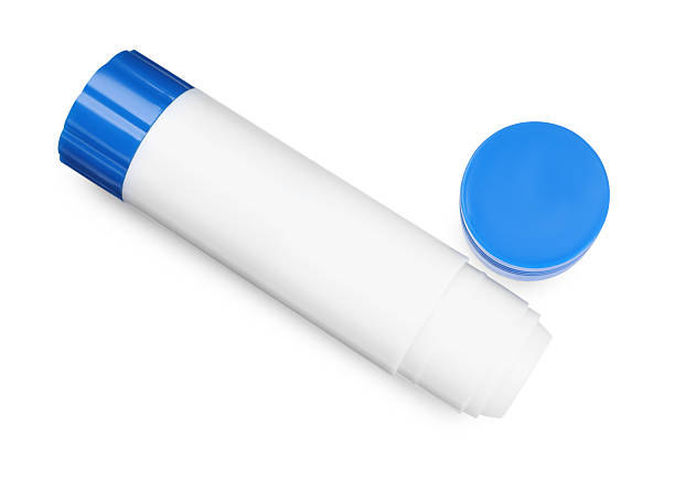 Tube of blue acrylic paint drips onto colored sticker. Artistic gouache in tubes concept