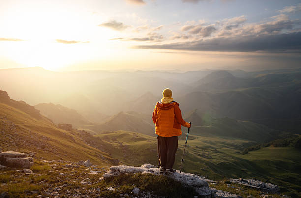 istock Hiker Meets Sunrise on a Scenic Mountain Peak 2232353796