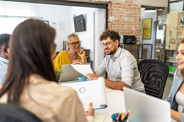 istock Business team analyzing documents and discussing strategies in modern office 2232355072