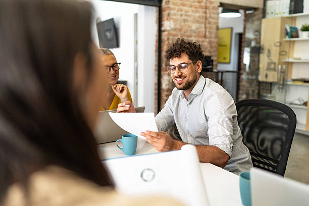 istock Business team discussing documents during meeting in modern office 2232355085