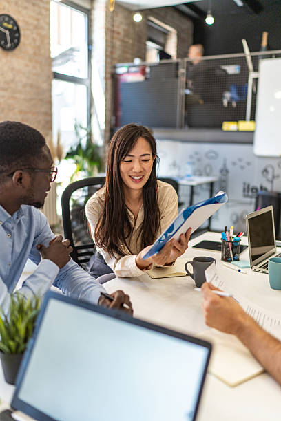 istock Business team discussing documents during meeting in modern office 2232355255
