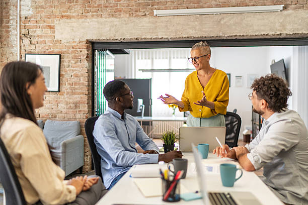 istock Team leader explaining new project to her colleagues during a meeting 2232355285