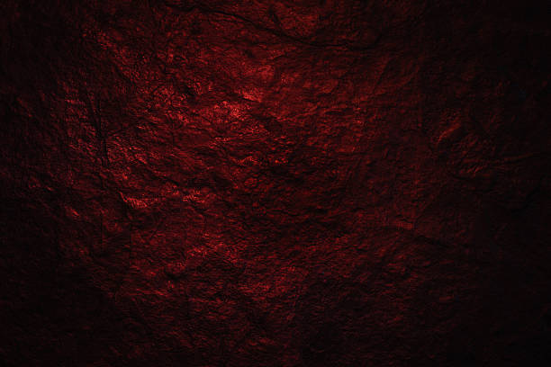 Dark Stone Texture. Natural Texture of a Black Stone Illuminated with Red light