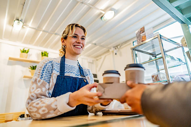 Waitress serving customer in a coffee shop