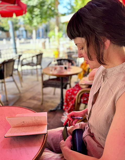 istock Young woman journalling 2232355737