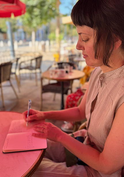 istock Young woman journalling 2232355738