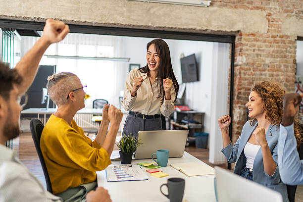 istock Excited business team celebrating success in modern office 2232355949