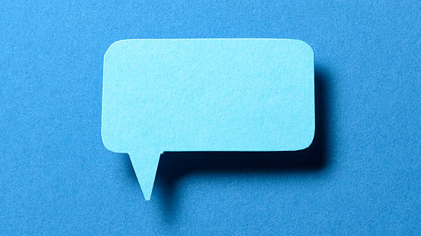 istock Blank cut out paper speech bubble with shadow and copy space for text on blue background, close-up flat lay top view conceptual backdrop 2232356687