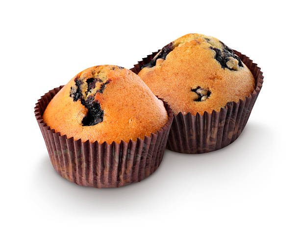 istock Tasty blueberry muffins in cupcake liners isolated on white 2232357148