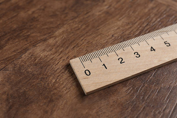 istock One ruler on wooden table, closeup. Space for text 2232357404