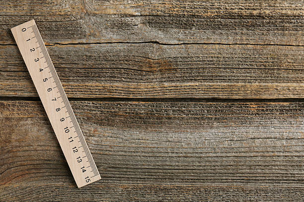 istock One ruler on wooden table, top view. Space for text 2232357406
