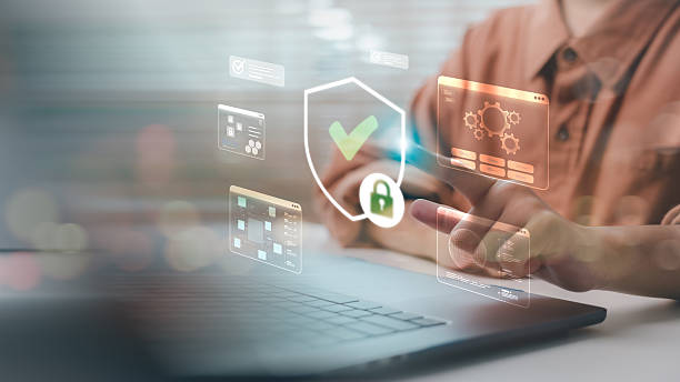 istock Businessman using laptop with digital shield and check mark. Concept of cybersecurity, secure access, data protection, online privacy and IT system safety technology for business. 2232359585
