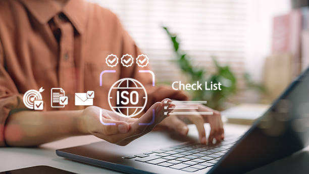 istock Businessman hand showing ISO certification with digital checklist. Concept of quality management, compliance audit, process improvement and international corporate governance system. 2232359657