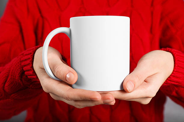 istock Woman holding blank white ceramic mug, closeup. Mockup for design 2232362832