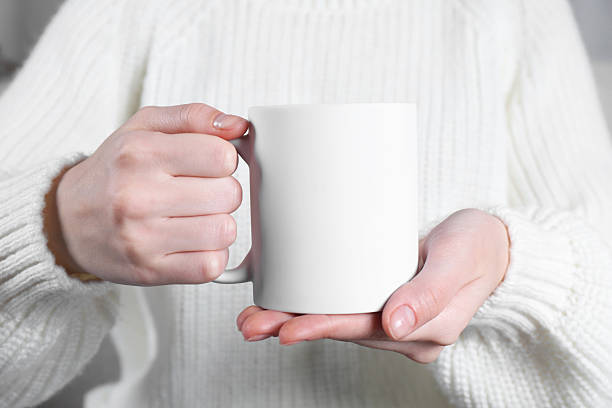 istock Woman holding blank white ceramic mug, closeup. Mockup for design 2232362838