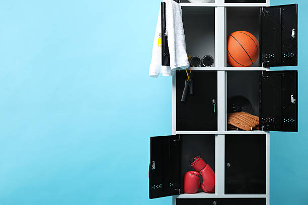istock Open lockers with sport equipment on light blue background, space for text 2232362965