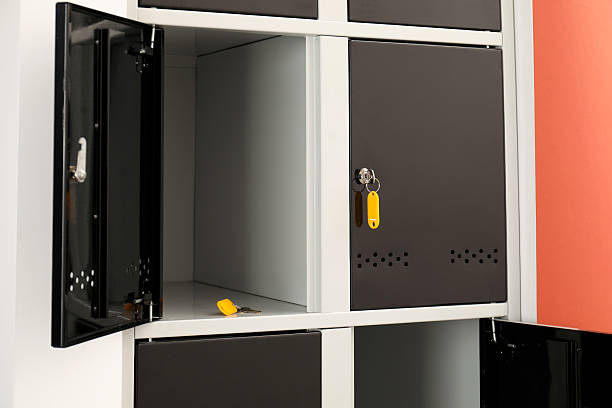istock Modern lockers with keys on coral background, closeup 2232362980