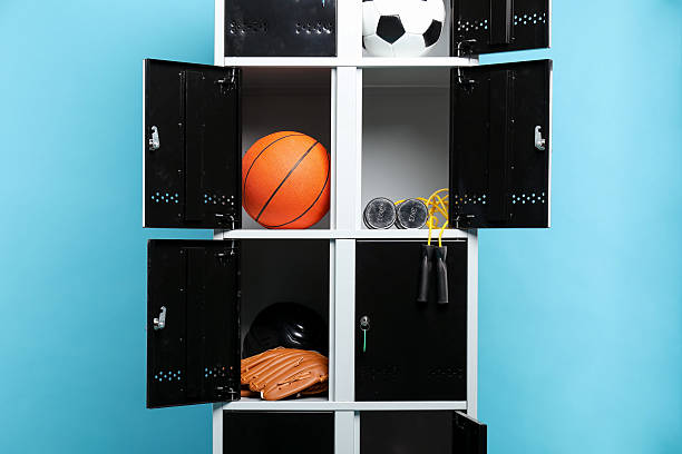 istock Open lockers with sport equipment on light blue background 2232363011