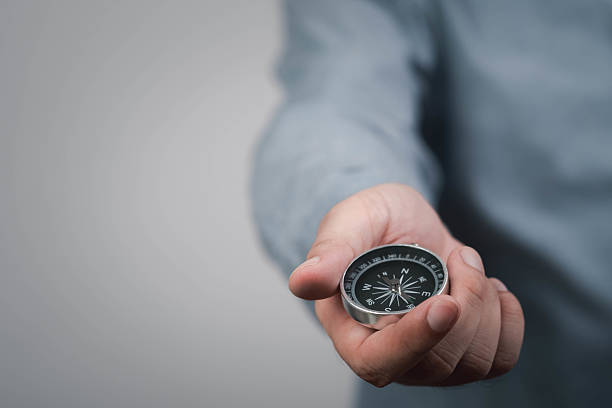 istock A person holds a compass in their hand, symbolizing direction, guidance, and exploration. 2232363142