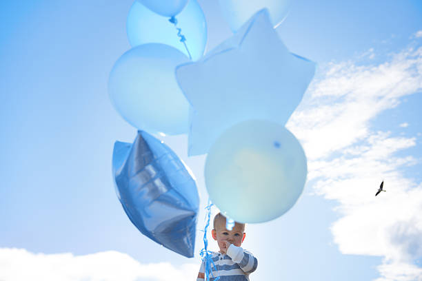 woman holding a blue balloon anniversary