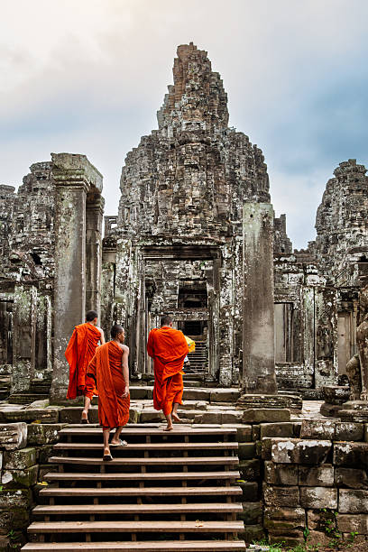 Siem Reap, Сambodia - February 24, 2016: Buddhist monk in Angkor Wat Cambodia. Although first constructed as an hindu temple later Angkor Wat became buddhist. Nowadays buddhist monks from all over the world come to visit this famous temple.