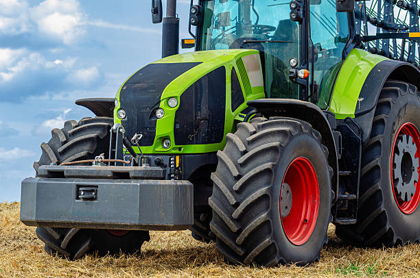 istock Modern tractor on stubble under cloudy sky. Concept of work in fields and agricultural industry. 2232366651