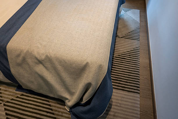 istock A serene bedroom corner featuring a neatly made bed and a cozy rug. 2232367674