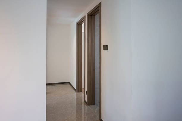 istock Empty hallway with wooden doors and white walls 2232367954