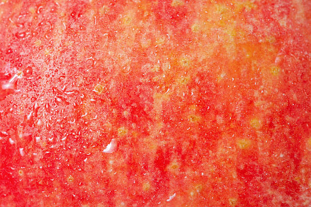 istock Red apple texture as a background with water drops. 2232368867