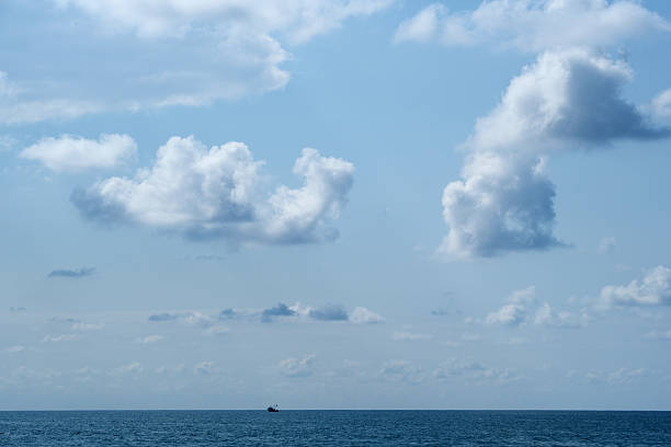 Blue sky with white clouds over the sea. Nature composition and background, copy space.