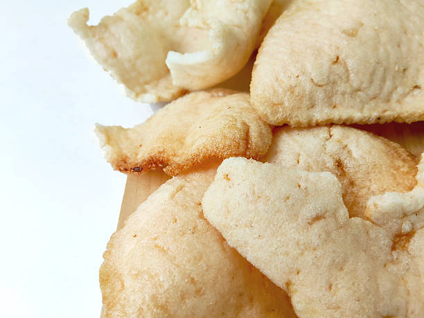 istock Savory Shrimp Crackers on a White Table with Wood 2232369531