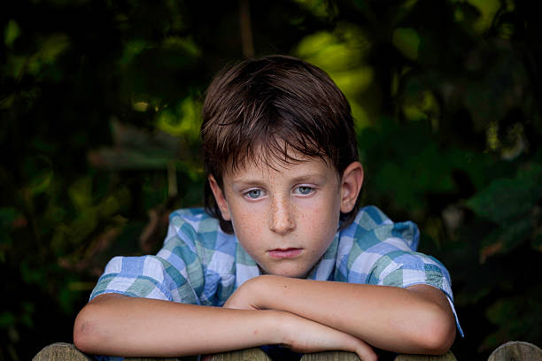 8-year-old boy next door gazing over his fence.